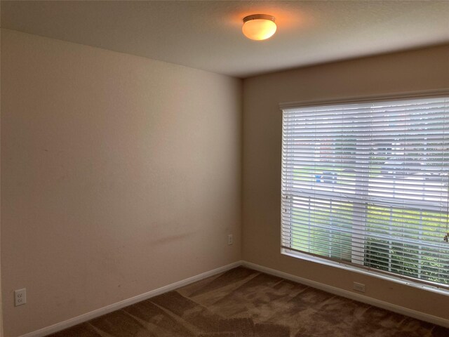 12223 Zenith Ridge Way, Humble, TX 77346 - empty room with plenty of natural light and carpet flooring