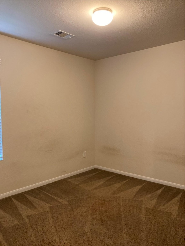 12223 Zenith Ridge Way, Humble, TX 77346 - empty room with dark carpet and a textured ceiling