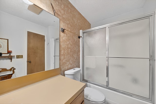 2970 Spanish Oaks Dr, Brenham, TX 77833 - bathroom featuring vanity, a textured ceiling, and enclosed tub / shower combo