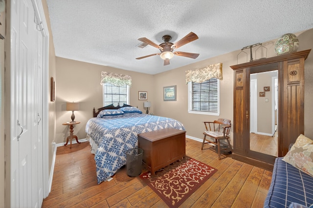 2970 Spanish Oaks Dr, Brenham, TX 77833 - bedroom featuring a textured ceiling, light wood-style floors, and ceiling fan