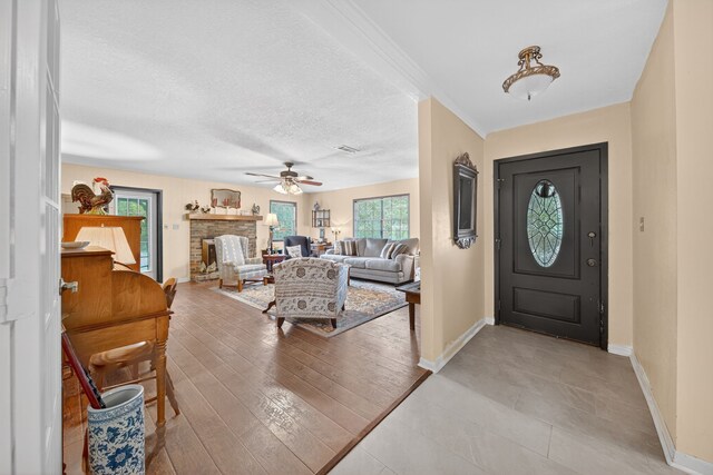 2970 Spanish Oaks Dr, Brenham, TX 77833 - entryway with a ceiling fan and a fireplace with raised hearth