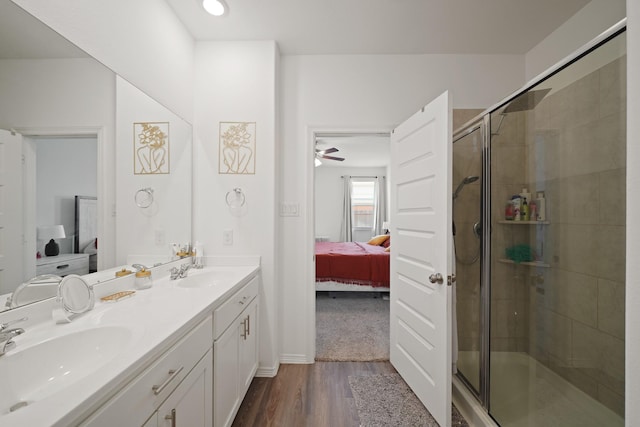 5958 First Blush Dr, Katy, TX 77493 - ensuite bathroom featuring double vanity, a shower stall, wood finished floors, and a ceiling fan