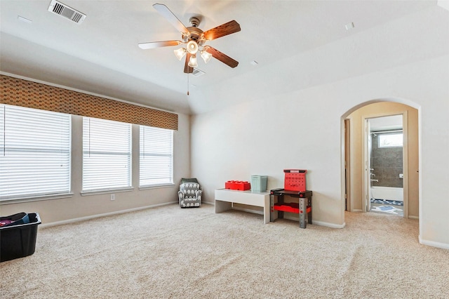 2961 Autumn Brook Ln, League City, TX 77573 - living area with arched walkways, healthy amount of natural light, carpet floors, and a ceiling fan