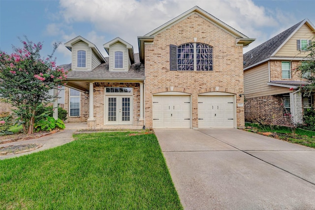 2961 Autumn Brook Ln, League City, TX 77573 - view of front facade featuring french doors, brick siding, driveway, and a front yard