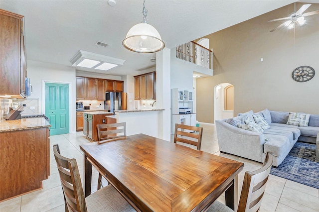 2961 Autumn Brook Ln, League City, TX 77573 - dining room featuring light tile patterned flooring, arched walkways, and ceiling fan