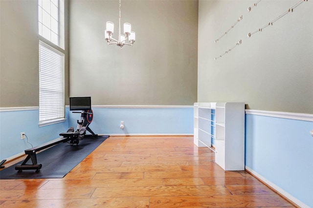 2961 Autumn Brook Ln, League City, TX 77573 - exercise area with hardwood / wood-style flooring, a chandelier, and healthy amount of natural light