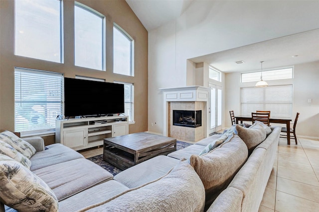 2961 Autumn Brook Ln, League City, TX 77573 - living room featuring light tile patterned flooring, plenty of natural light, a high ceiling, and a tiled fireplace