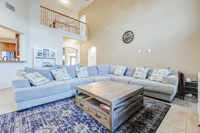 2961 Autumn Brook Ln, League City, TX 77573 - living area with light tile patterned floors, arched walkways, and a high ceiling