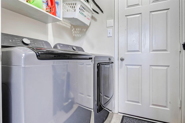 2961 Autumn Brook Ln, League City, TX 77573 - laundry room with washing machine and clothes dryer and light tile patterned flooring