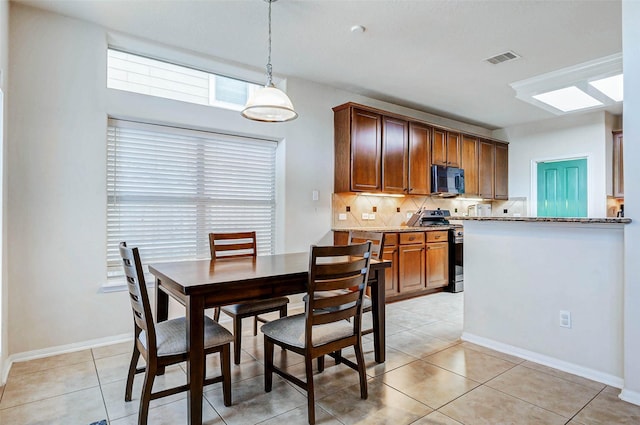 2961 Autumn Brook Ln, League City, TX 77573 - dining room with light tile patterned flooring and baseboards