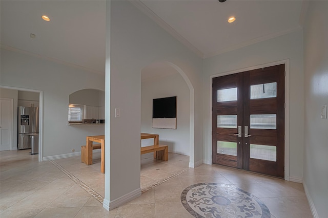 11914 Ashmead Dr, Houston, TX 77077 - entryway featuring ornamental molding, french doors, arched walkways, inlaid floor details, and healthy amount of natural light
