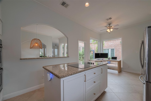 11914 Ashmead Dr, Houston, TX 77077 - kitchen with freestanding refrigerator, black electric cooktop, a ceiling fan, ornamental molding, and white cabinets