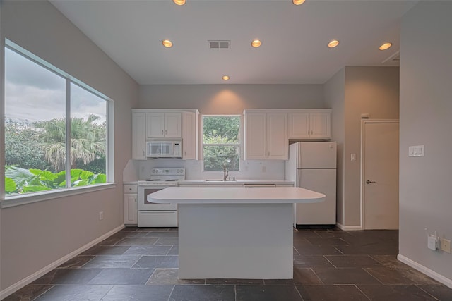 11914 Ashmead Dr, Houston, TX 77077 - kitchen featuring white appliances, healthy amount of natural light, a kitchen island, light countertops, and recessed lighting