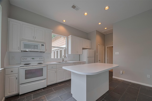 11914 Ashmead Dr, Houston, TX 77077 - kitchen with white appliances, white cabinetry, light countertops, a center island, and recessed lighting