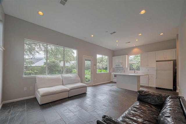 11914 Ashmead Dr, Houston, TX 77077 - living area with recessed lighting and stone tile flooring