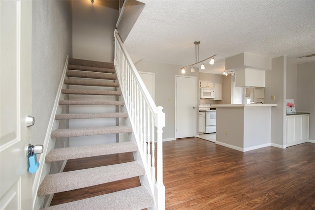 10615 Briar Forest Dr Unit 402, Houston, TX 77042 - stairs with wood finished floors and a textured ceiling