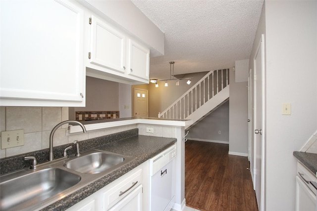 10615 Briar Forest Dr Unit 402, Houston, TX 77042 - kitchen featuring dishwasher, dark countertops, white cabinetry, decorative backsplash, and a textured ceiling