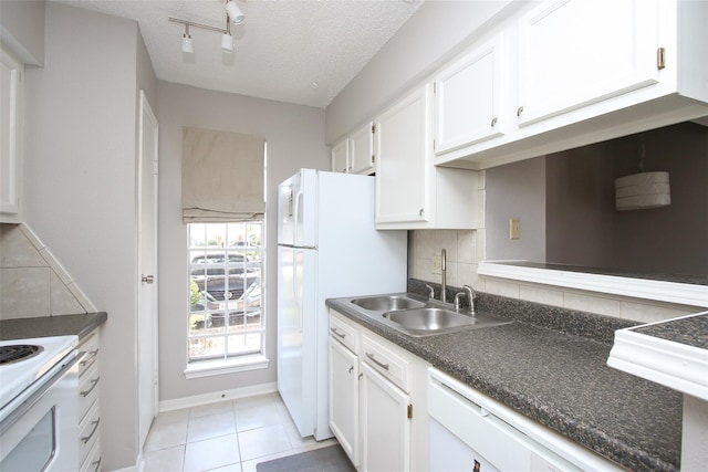 10615 Briar Forest Dr Unit 402, Houston, TX 77042 - kitchen with white cabinets, white appliances, decorative backsplash, dark countertops, and a textured ceiling