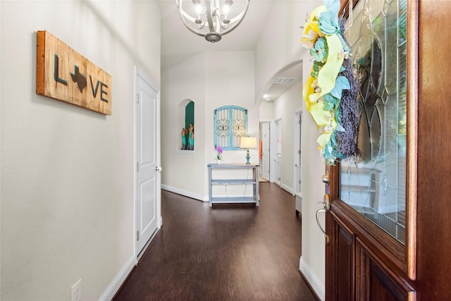 9906 Deborah Colony Ln, Humble, TX 77396 - entryway featuring dark wood-style floors, a chandelier, and arched walkways
