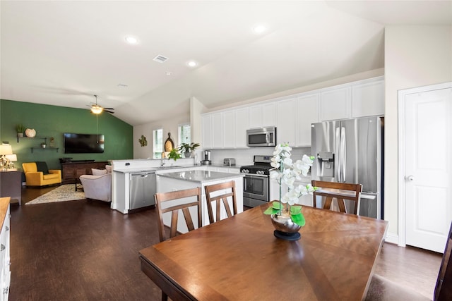 9906 Deborah Colony Ln, Humble, TX 77396 - dining space featuring lofted ceiling, dark wood-style floors, and ceiling fan