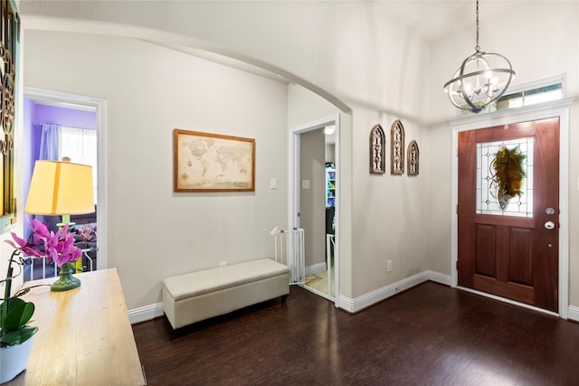 9906 Deborah Colony Ln, Humble, TX 77396 - foyer with a chandelier, dark wood-type flooring, and arched walkways