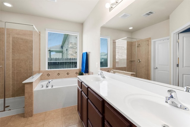 9906 Deborah Colony Ln, Humble, TX 77396 - full bath with a stall shower, a garden tub, double vanity, tile patterned floors, and recessed lighting
