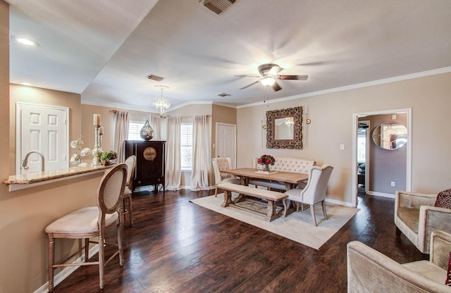 2516 Vaughn St, Houston, TX 77093 - dining space with dark wood-style floors, crown molding, ceiling fan, and a chandelier