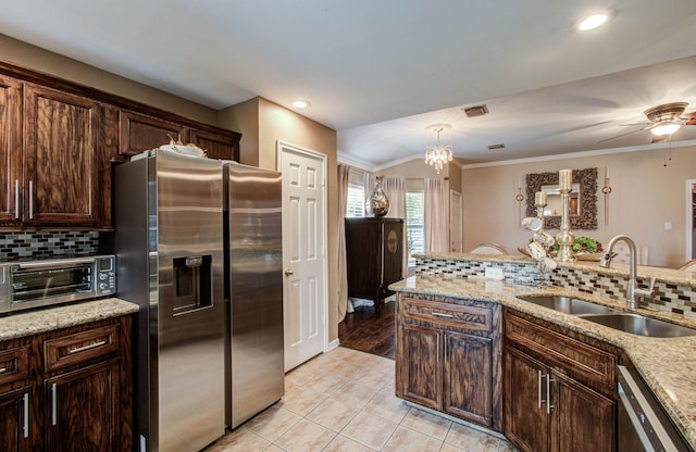 2516 Vaughn St, Houston, TX 77093 - kitchen featuring appliances with stainless steel finishes, tasteful backsplash, ornamental molding, light tile patterned floors, and vaulted ceiling