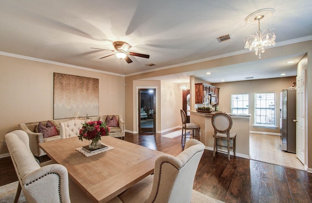 2516 Vaughn St, Houston, TX 77093 - dining space with dark wood finished floors, a ceiling fan, a chandelier, ornamental molding, and recessed lighting