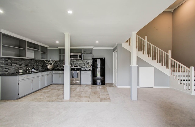 2516 Vaughn St, Houston, TX 77093 - kitchen featuring stainless steel appliances, open shelves, dark countertops, tasteful backsplash, and light carpet