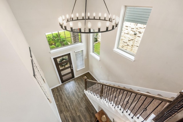 7906 Pershing Ave, Magnolia, TX 77354 - foyer entrance with a chandelier, wood finished floors, a high ceiling, and stairway