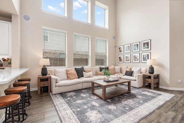 7906 Pershing Ave, Magnolia, TX 77354 - living area with plenty of natural light, a high ceiling, and wood finished floors