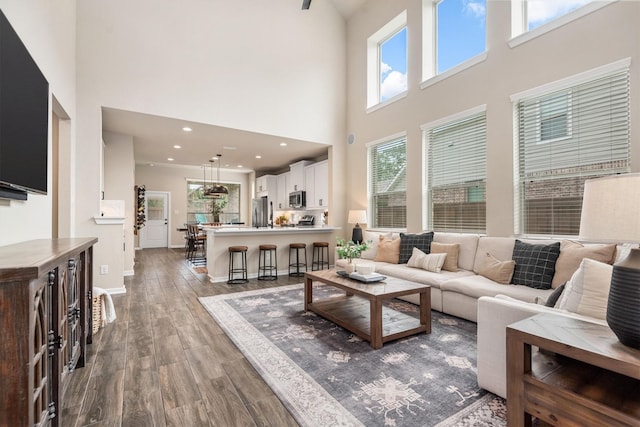7906 Pershing Ave, Magnolia, TX 77354 - living area featuring a towering ceiling and wood finished floors