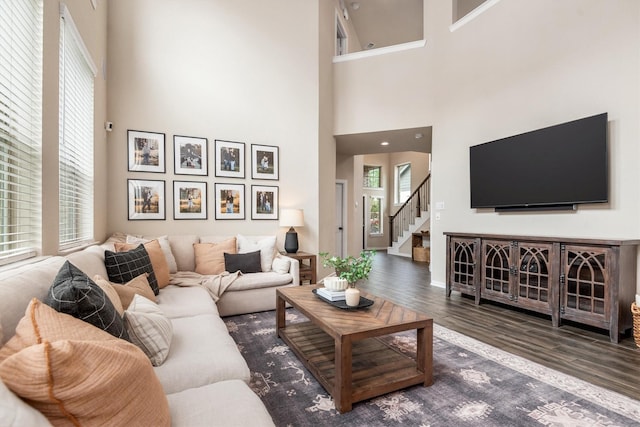 7906 Pershing Ave, Magnolia, TX 77354 - living room with a high ceiling, wood finished floors, and stairway