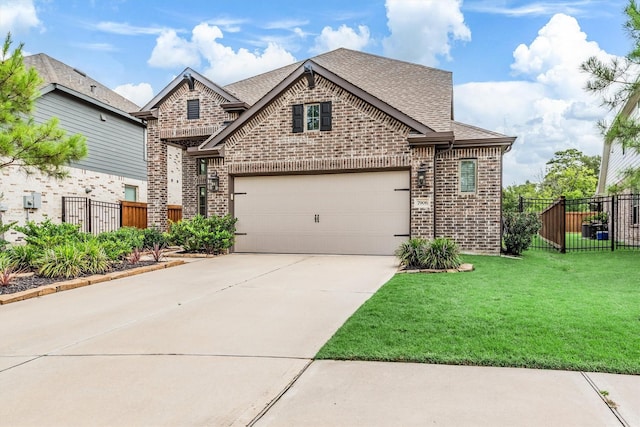 7906 Pershing Ave, Magnolia, TX 77354 - french country home featuring brick siding, roof with shingles, concrete driveway, and an attached garage