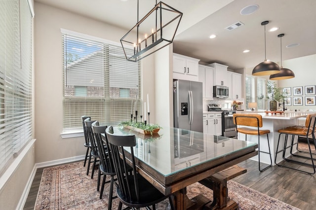 7906 Pershing Ave, Magnolia, TX 77354 - dining space featuring healthy amount of natural light, dark wood finished floors, recessed lighting, and a chandelier