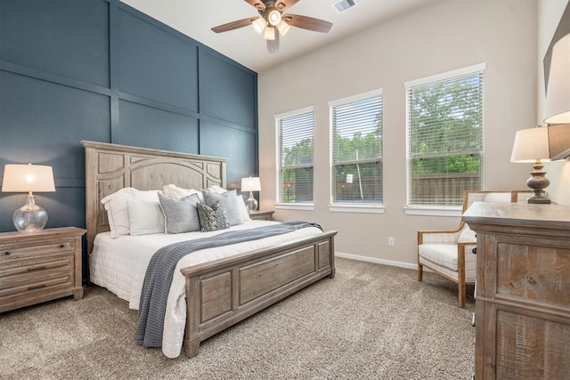7906 Pershing Ave, Magnolia, TX 77354 - bedroom featuring light carpet, multiple windows, and a ceiling fan