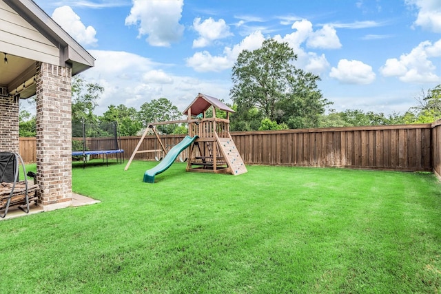 7906 Pershing Ave, Magnolia, TX 77354 - fenced backyard with a trampoline and a playground