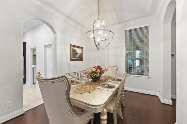 6 Inland Prairie Dr, Tomball, TX 77375 - dining room featuring arched walkways, a chandelier, wood-type flooring, and crown molding