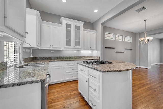 542 Bomar St, Houston, TX 77006 - kitchen with appliances with stainless steel finishes, light wood-style floors, white cabinetry, light stone counters, and recessed lighting