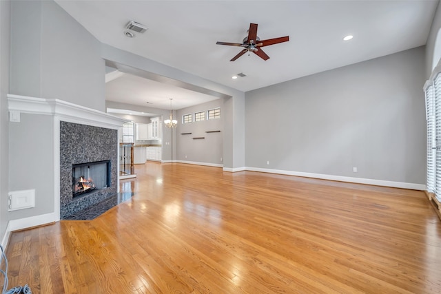 542 Bomar St, Houston, TX 77006 - unfurnished living room featuring a fireplace, a ceiling fan, light wood-type flooring, a chandelier, and recessed lighting