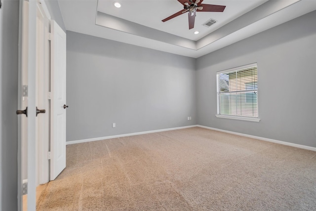 542 Bomar St, Houston, TX 77006 - empty room featuring light colored carpet, a ceiling fan, a tray ceiling, and recessed lighting