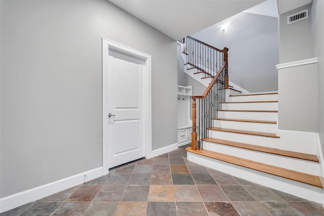 542 Bomar St, Houston, TX 77006 - staircase featuring stone finish floors and baseboards