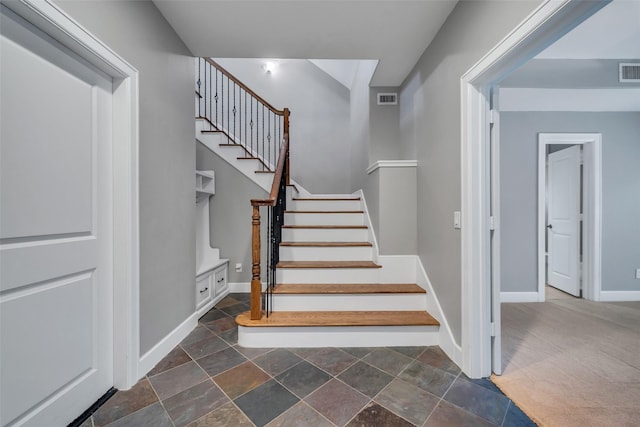542 Bomar St, Houston, TX 77006 - staircase featuring baseboards and stone finish floors
