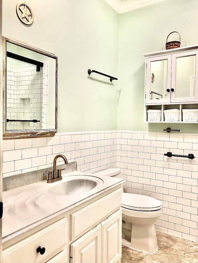 2006 Buffalo Ter, Houston, TX 77019 - bathroom with tile walls, vanity, ornamental molding, and wainscoting