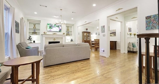 2006 Buffalo Ter, Houston, TX 77019 - living room featuring ornamental molding, built in shelves, light wood-type flooring, recessed lighting, and a fireplace
