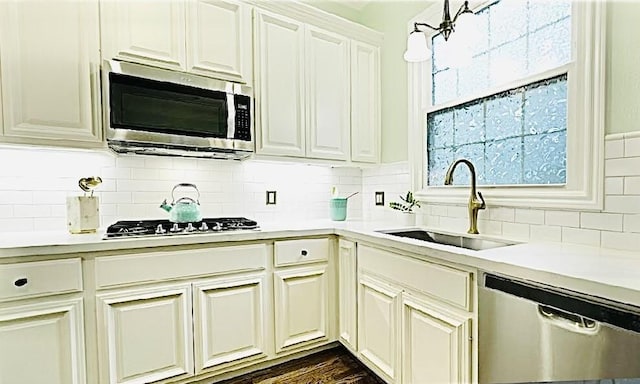 2006 Buffalo Ter, Houston, TX 77019 - kitchen with appliances with stainless steel finishes, light countertops, backsplash, and white cabinetry