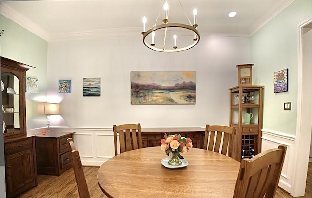 2006 Buffalo Ter, Houston, TX 77019 - dining area featuring light wood-style flooring, a chandelier, ornamental molding, a wainscoted wall, and a decorative wall