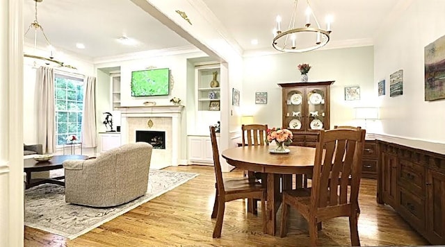 2006 Buffalo Ter, Houston, TX 77019 - dining space featuring a premium fireplace, crown molding, wood finished floors, a chandelier, and recessed lighting