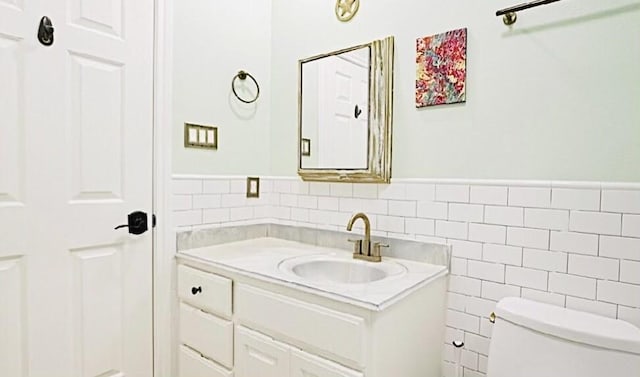 2006 Buffalo Ter, Houston, TX 77019 - half bath with vanity, tile walls, and a wainscoted wall